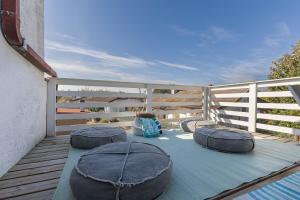 a balcony with four pillows on a blue blanket at GuestHost - Parco del Sole Residence Flat with Terrace in lido degli scacchi