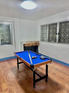 a ping pong table in a room with ahibition at Oslob Cozy Home in Oslob