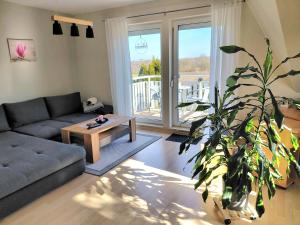a living room with a couch and a plant at Ferienwohnung Janine in Neubrandenburg