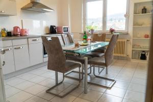 a kitchen with a table and chairs in it at Selina's Apartment in Oberthal