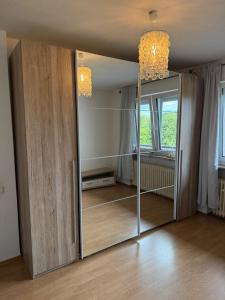 a sliding glass door in a room with a mirror at Selina's Apartment in Oberthal