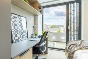 a bedroom with a desk and a bed and a window at Argyl - Broga House Central Cork Accommodation in Cork