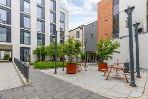 a courtyard with tables and trees and buildings at Argyl - Broga House Central Cork Accommodation in Cork