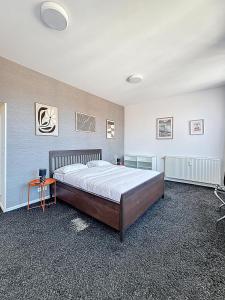 a bedroom with a large bed and a table at Keyless Hotel - Van Gaver in Brussels +10 photos