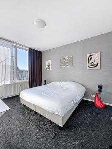 a bedroom with a large bed and a window at Keyless Hotel - Van Gaver in Brussels
