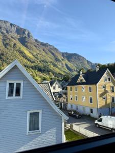 a view of a town with houses and a mountain at Odda Gangdal Apartments in Odda
