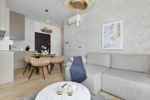 a living room with a couch and a table at Sol Marina Apartment by Solarento in Wiślinka