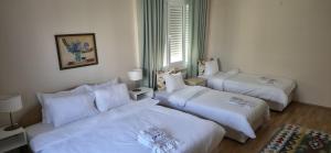a hotel room with two beds and a couch at Ephesus Suites in Selçuk