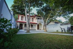 a large house with trees in the yard at Chamindu Villa Matara in Matara