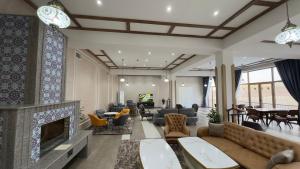 a living room with a couch and a fireplace at Lazgi Boutique & Spa Hotel in Khiva