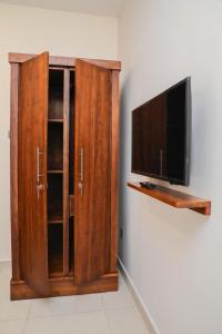 a wooden entertainment center with a flat screen tv at Chamindu Villa Matara in Matara