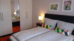 a small bedroom with a bed and a mirror at Apartment U - relax in Leipzig