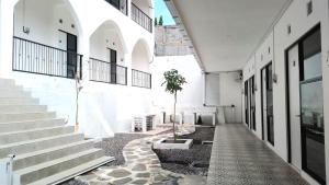 a hallway of a building with stairs and a plant at Kims Stay Syariah in Jember