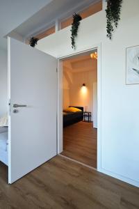 a room with a door leading to a bedroom at Pelster´s Apartments in Diepholz