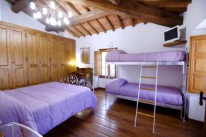a bedroom with two bunk beds with purple sheets at La Locanda di Giulia in Arezzo