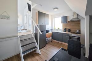 a kitchen with a staircase in a small room at Pelster´s Apartments in Diepholz +23 photos