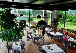 a restaurant with tables and people sitting at tables at Eco Camp Lake Mladost in Veles +55 photos