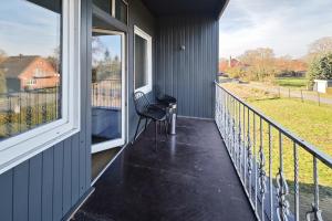 a balcony with a bench on the side of a house at Pelster´s Apartments in Diepholz
