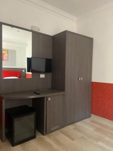a room with a bed with a desk and a mirror at Hotel Center 2 in Rome