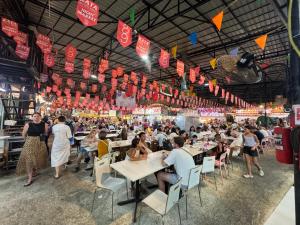 a crowd of people sitting at tables in a restaurant at KataKeet in Kata Beach