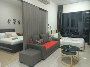 a living room with a couch and a bed at Continew Residence by TM House in Kuala Lumpur
