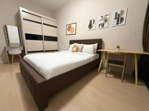 a bedroom with a bed with a teddy bear on it at Continew Residence by TM House in Kuala Lumpur