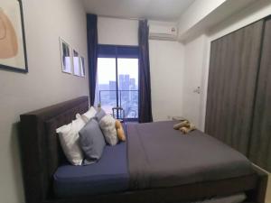 a bedroom with a bed with pillows and a window at Continew Residence by TM House in Kuala Lumpur