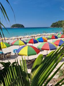 a group of colorful umbrellas on a beach at KataKeet in Kata Beach