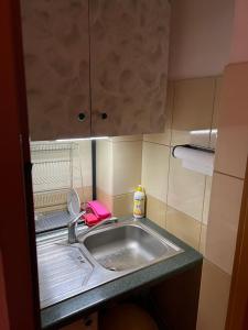 a small kitchen with a sink and a cabinet at Podkamiencem in Odrzykoń +46 photos