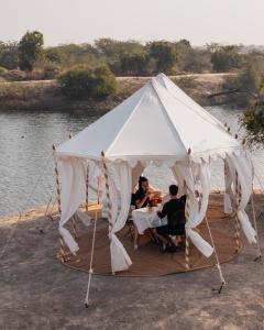two people sitting at a table under a white tent at Rohet Garh in Rohat
