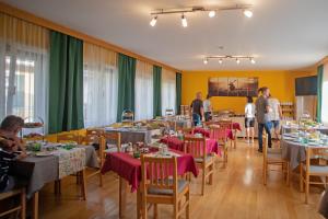 a dining room with tables and chairs with people in it at Frühstückspension Josefinum in Bad Aussee