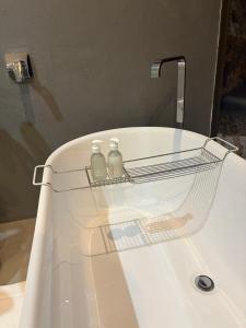 two bottles sitting on top of a bathroom sink at Swanepoel Guesthouse in Jeffreys Bay