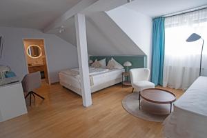 a bedroom with a bed and a table and chairs at Frühstückspension Josefinum in Bad Aussee