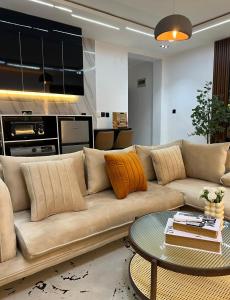 a living room with a couch and a table at TheEliteHavenshortlet in Lekki