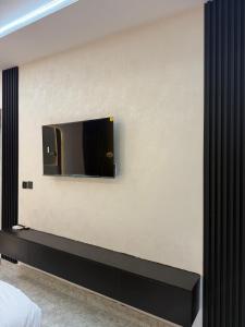 a bedroom with a tv on a wall at TheEliteHavenshortlet in Lekki