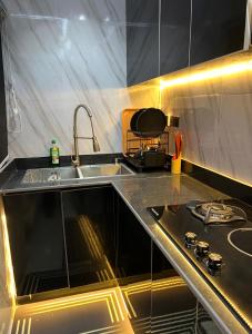 a kitchen with a sink and a stove at TheEliteHavenshortlet in Lekki