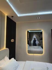 a hotel room with a bed and a mirror at TheEliteHavenshortlet in Lekki