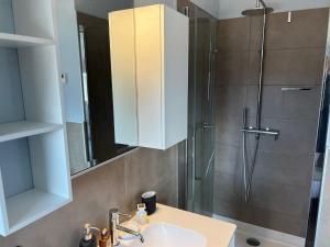 a bathroom with a sink and a shower at Attico Don Minzoni in Intra +8 photos