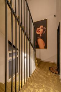 a staircase with a picture of a woman on the wall at ARI Central Location in Arad +122 photos