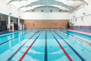 a large swimming pool with an empty lanes at CM Serviced Apartment Shenzhen Hillside in Shenzhen