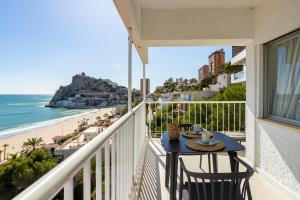 a balcony with a table and a view of the beach at Apartamentos Mirador in Benidorm