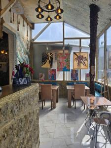 a restaurant with tables and chairs in a room at Hirmas boutique hotel in Tbilisi City