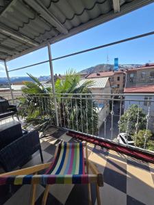 a balcony with chairs and a view of a city at Hirmas boutique hotel in Tbilisi City