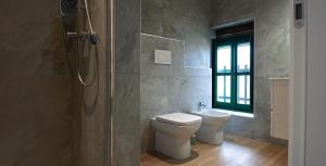 ein Badezimmer mit Toilette und Dusche in der Unterkunft Da Cuful in Reana del Roiale + 30 Fotos