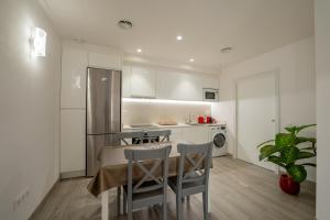 a kitchen with a table and chairs in a room at Mimi's Apartment in En Corts in Valencia
