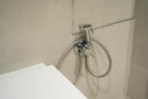 a shower in a bathroom with a shower head at Mimi's Apartment in En Corts in Valencia +31 photos