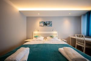 a bedroom with a large bed with two pillows at Hotel Haus Hohne in Hohne