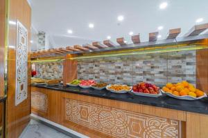 a buffet line with many plates of fruits and vegetables at Grand Barhan Hotel Alanya in Alanya
