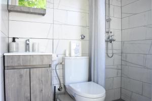 a bathroom with a toilet and a sink and a shower at Summer Retreat in Sithonia #FeelsLikeHome in Vourvourou +8 photos