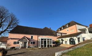 a group of buildings in a yard at Hotel St. Paulushof in Niedermohr